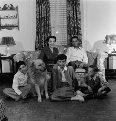 Portrait Of Black Family With Dog At Home