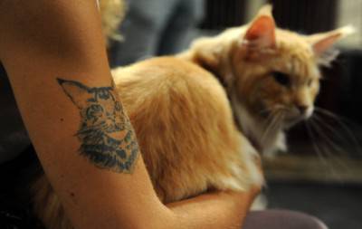 A woman holds her cat on August 6, 2011