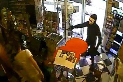 Robber-with-gun-is-no-match-for-ciggie-shop-dog