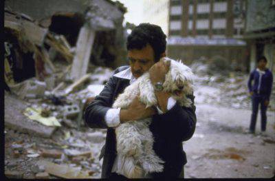 image of man hugging his dog after his 2 children died in earthquake. (Photo by Charles Bonnay/The LIFE Images Collection/Getty Images)