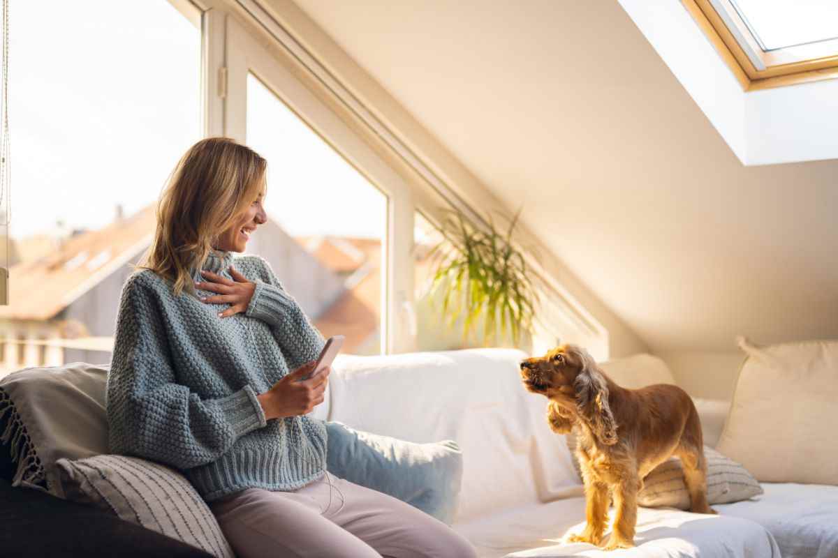 ragazza sul divano con cane che abbaia
